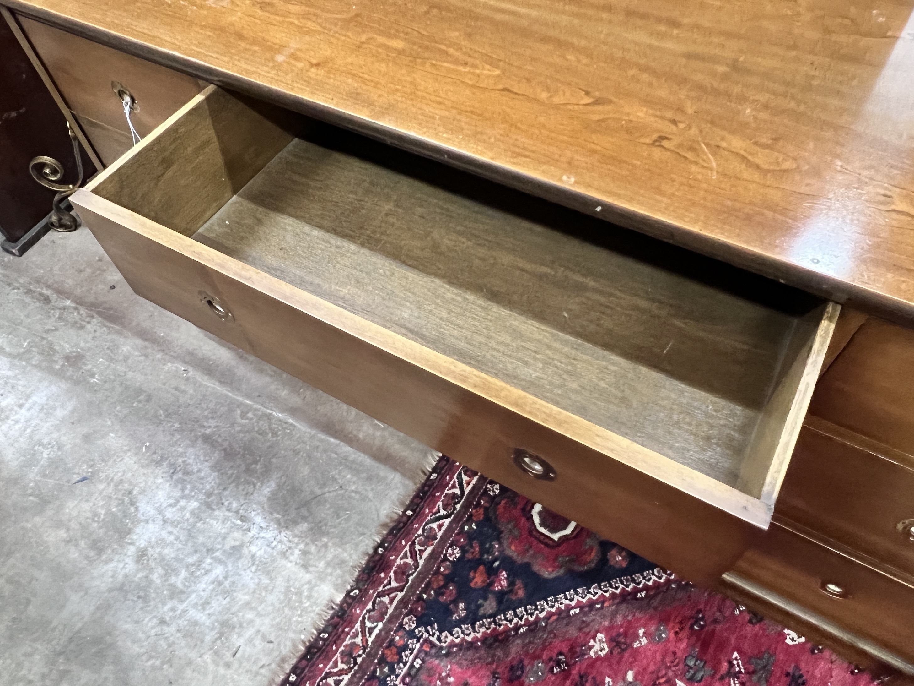 A reproduction mahogany military style dresser fitted seven small drawers, with recessed brass handles, width 153cm, depth 48cm, height 74cm